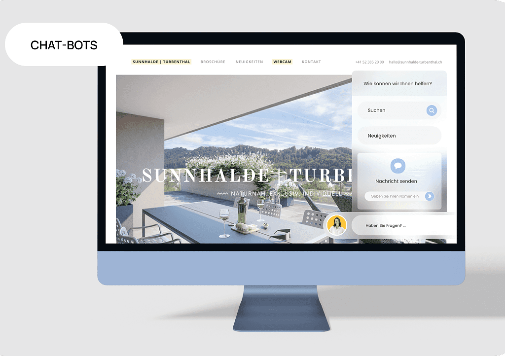 Ein Computerbildschirm zeigt eine Website eines Immobilienunternehmens mit Chatbots.