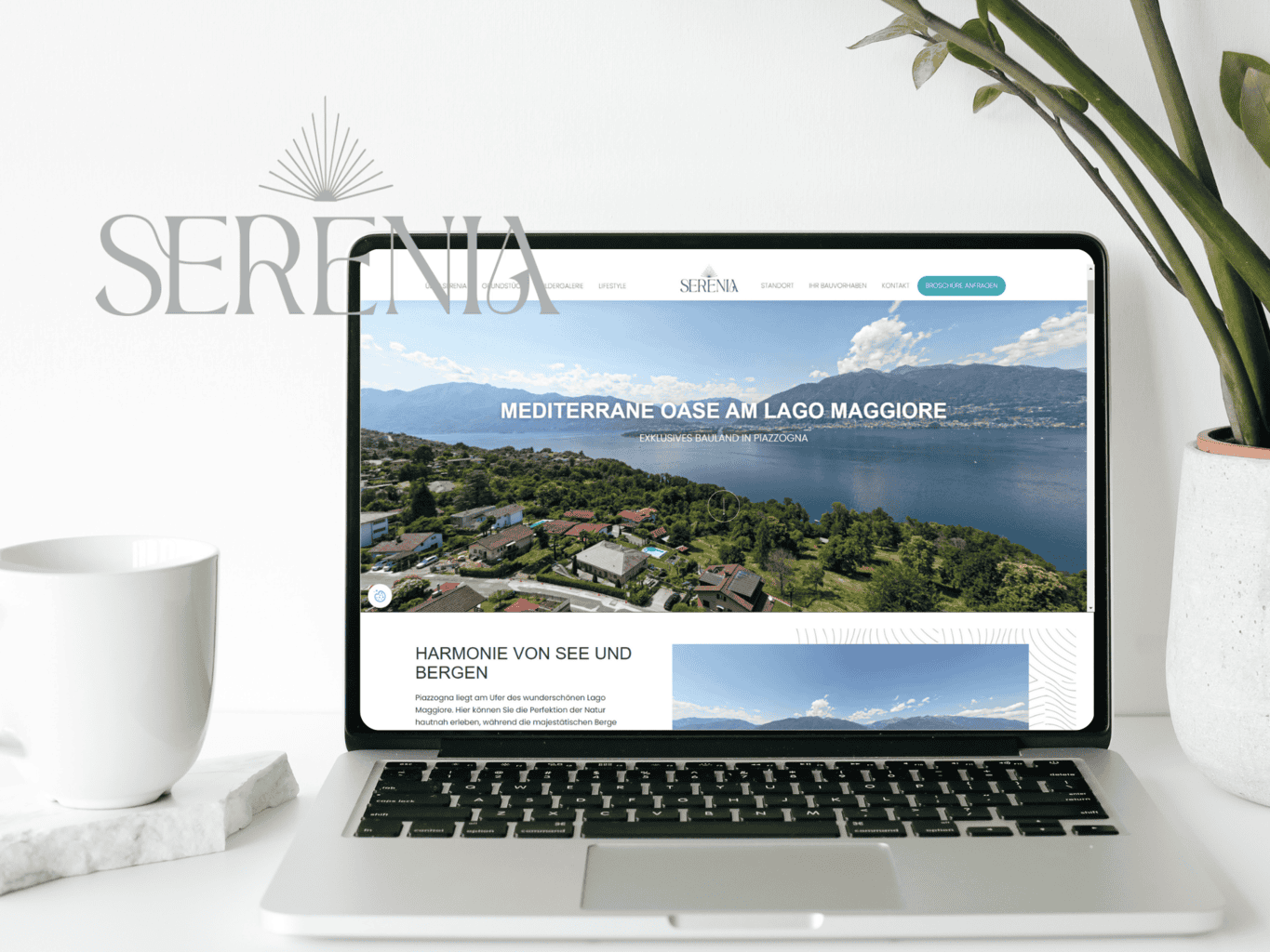 Laptop on a desk displaying a real estate website with serene lake views.