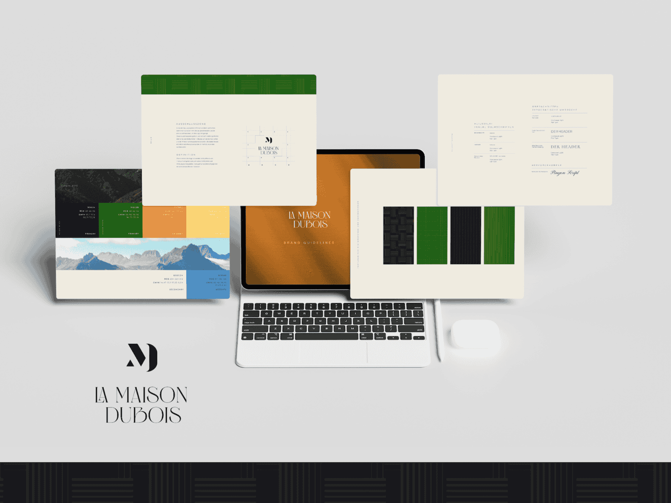A digital presentation of a corporate identity package for "la maison dubois," featuring business cards, letterheads, and a laptop with the design displayed on the screen.