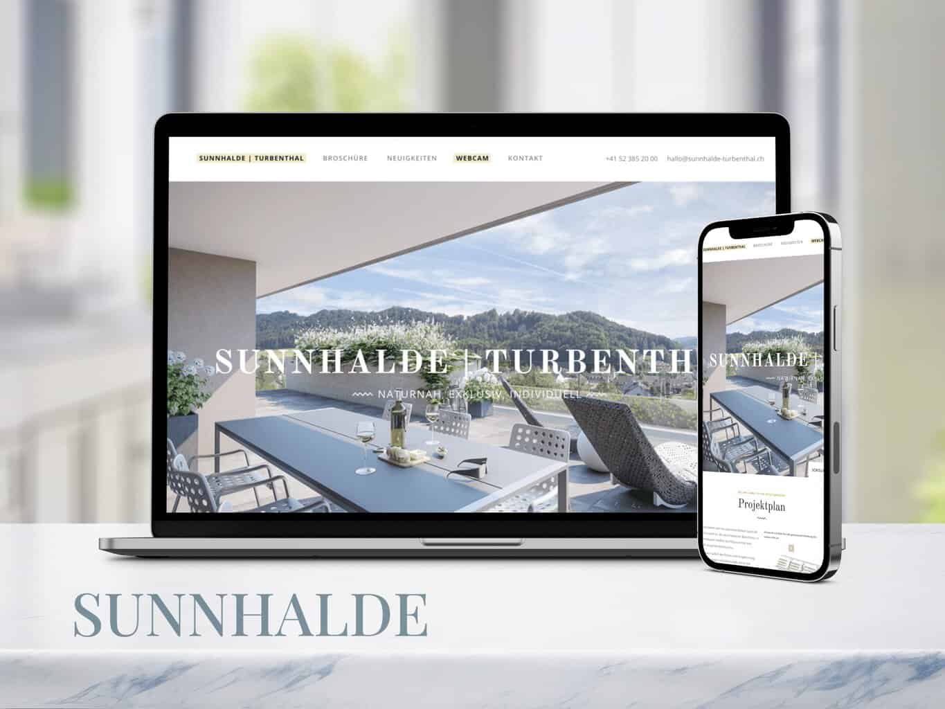 A laptop and smartphone showcase the Sunnhalde website with an outdoor dining setup against a mountainous backdrop, highlighting the elegance that an Immobilien Marketing Agentur can bring to property presentations.