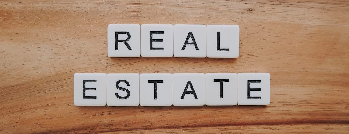 Letter tiles spelling out Real Estate market.