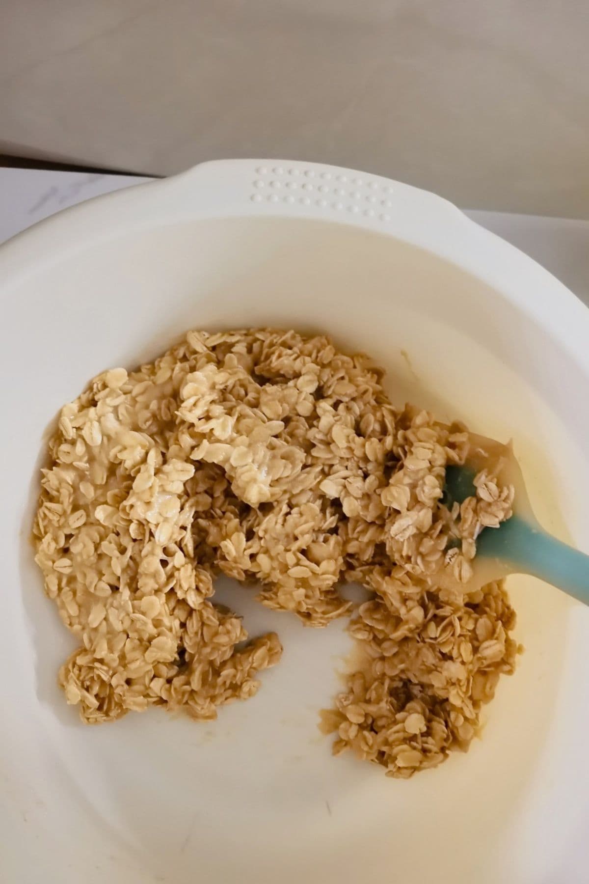 adding oats and mixing into a thick, sticky dough