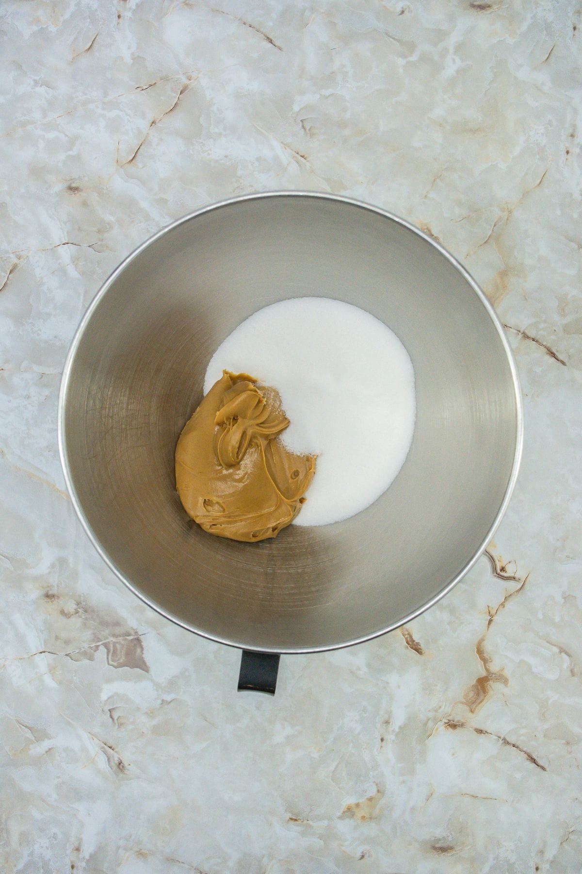 peanut butter and sugar in a stand mixer bowl