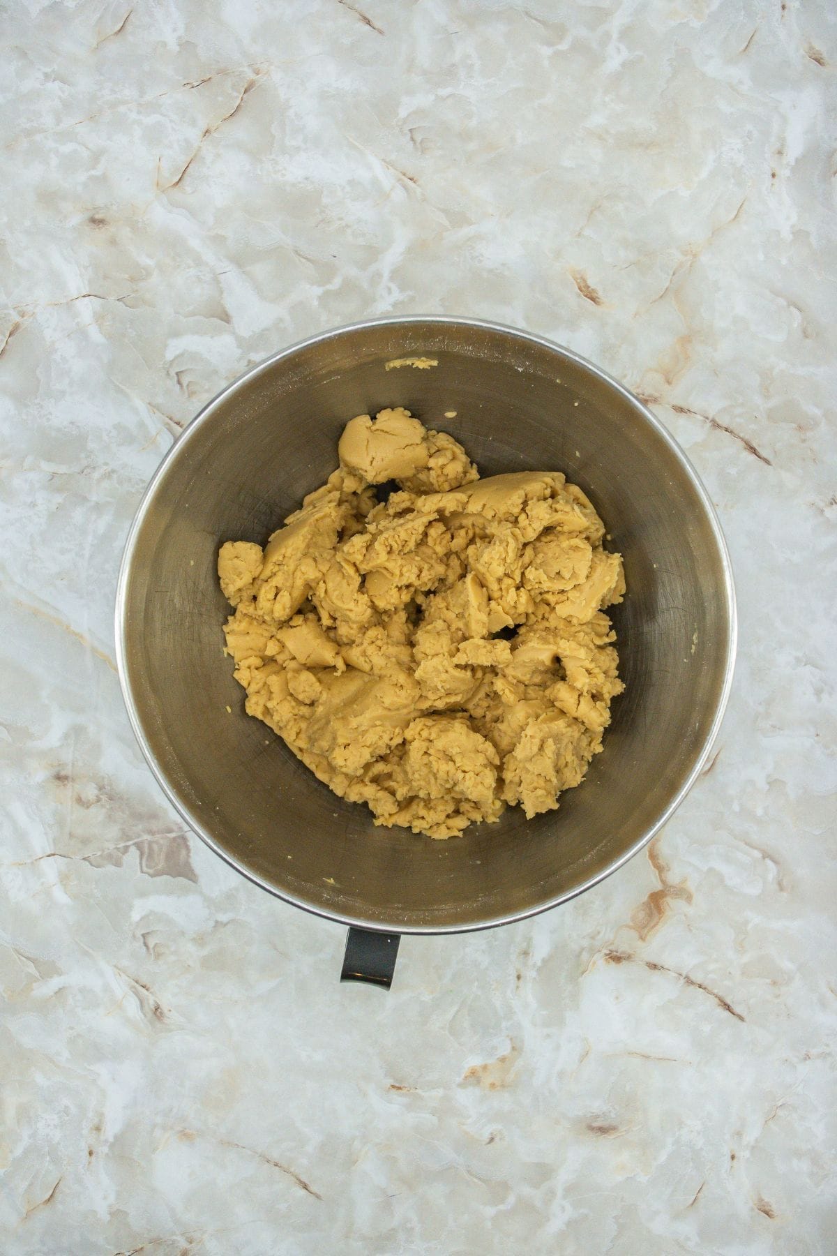 a mixture of creamy peanut butter, unsalted butter, and powdered sugar in a stand mixer bowl
