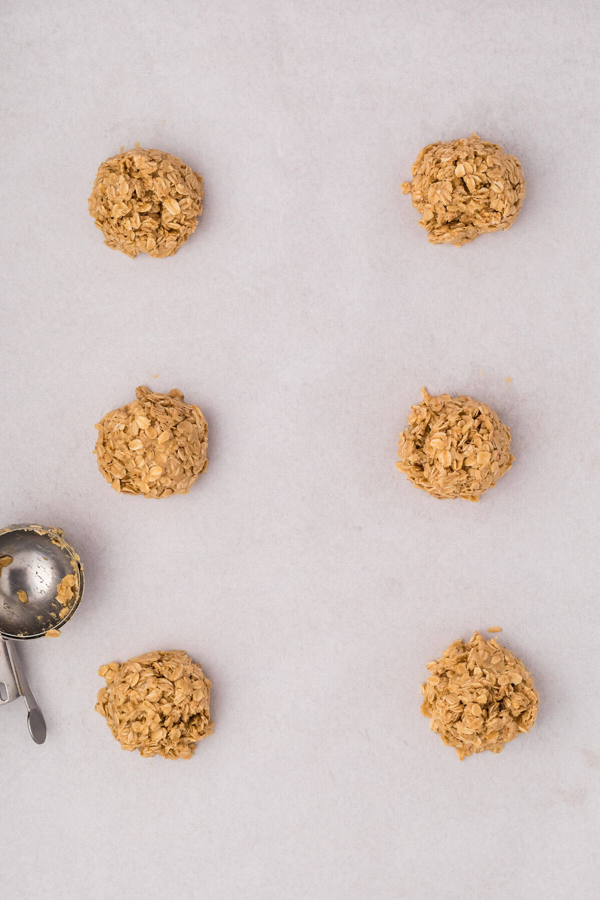 3 ingredient cookie dough after being scoped and still in a mound shape on the cookie sheet