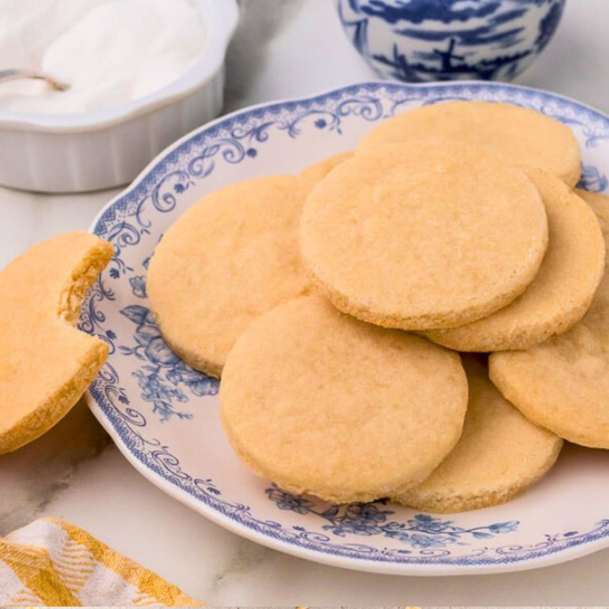 3 ingredient shortbread cookies stacked on a decorative blue plate