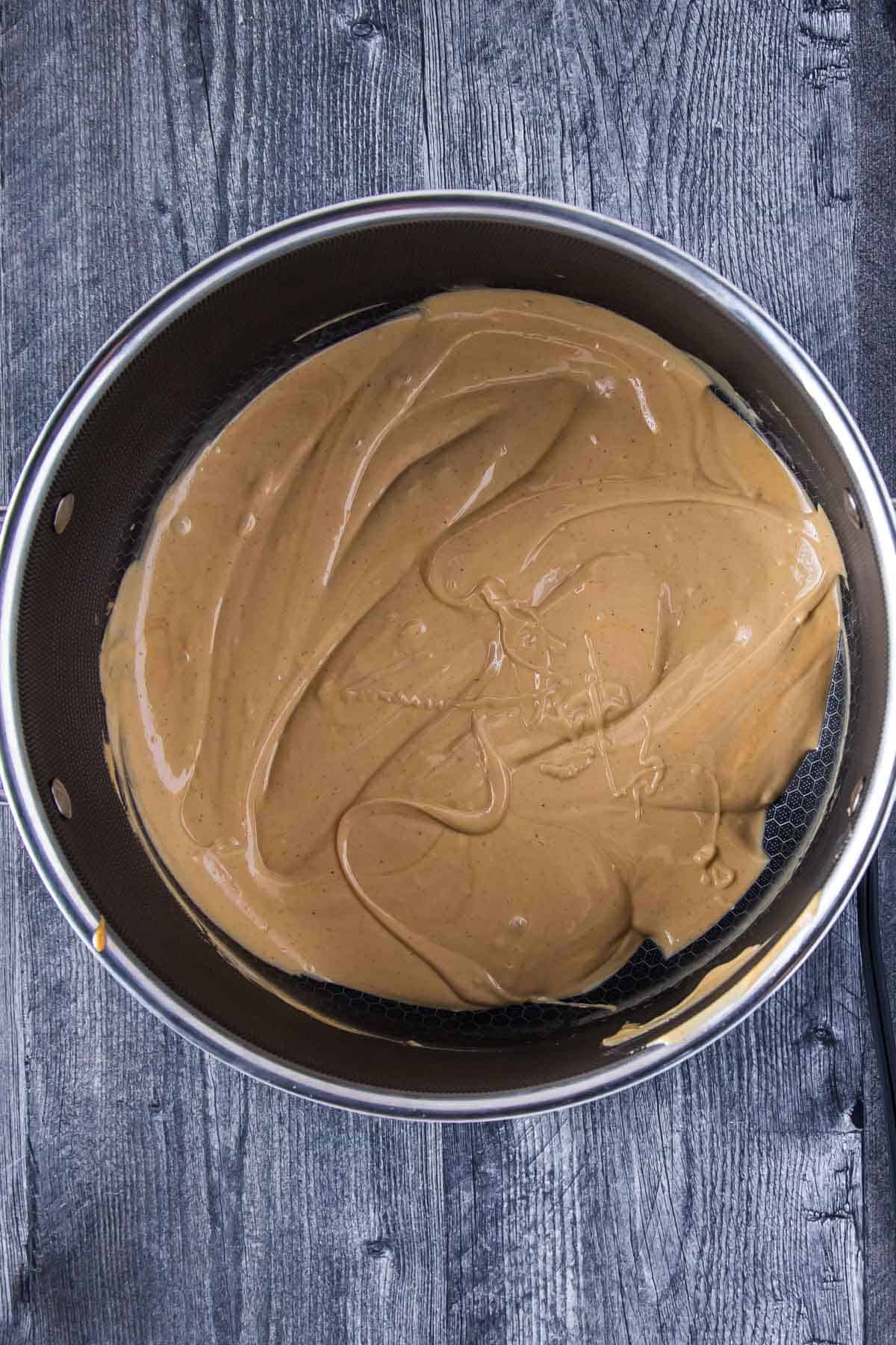melted mixture of white chocolate chips and creamy peanut butter in a large pot