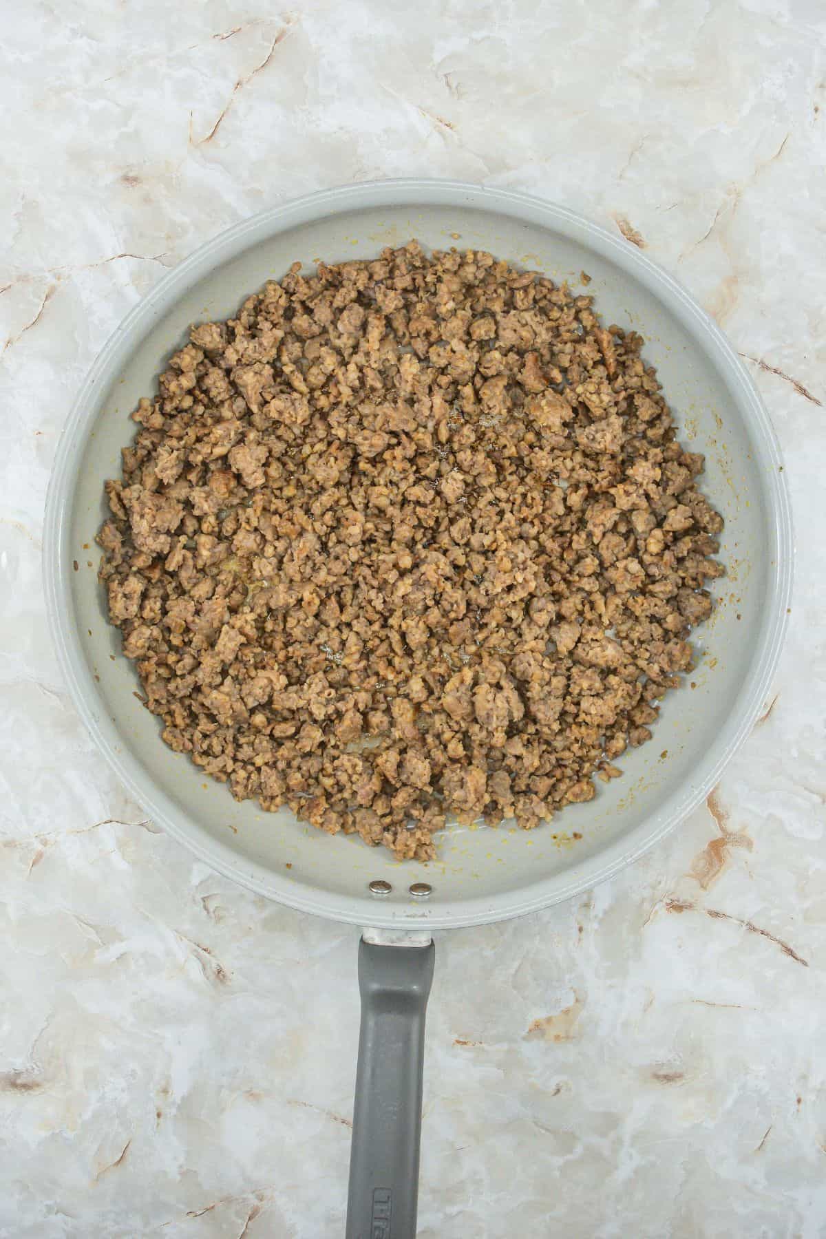 Biscuits and Gravy Casserole frying sausage until its brown