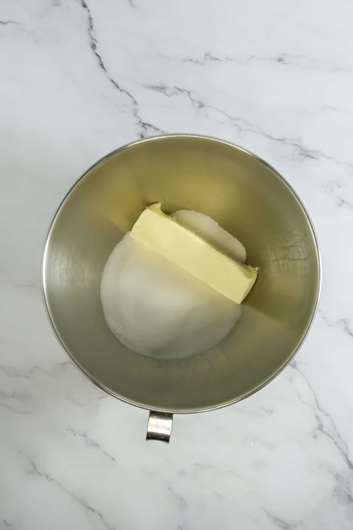 Mixing butter and sugar in a bowl.