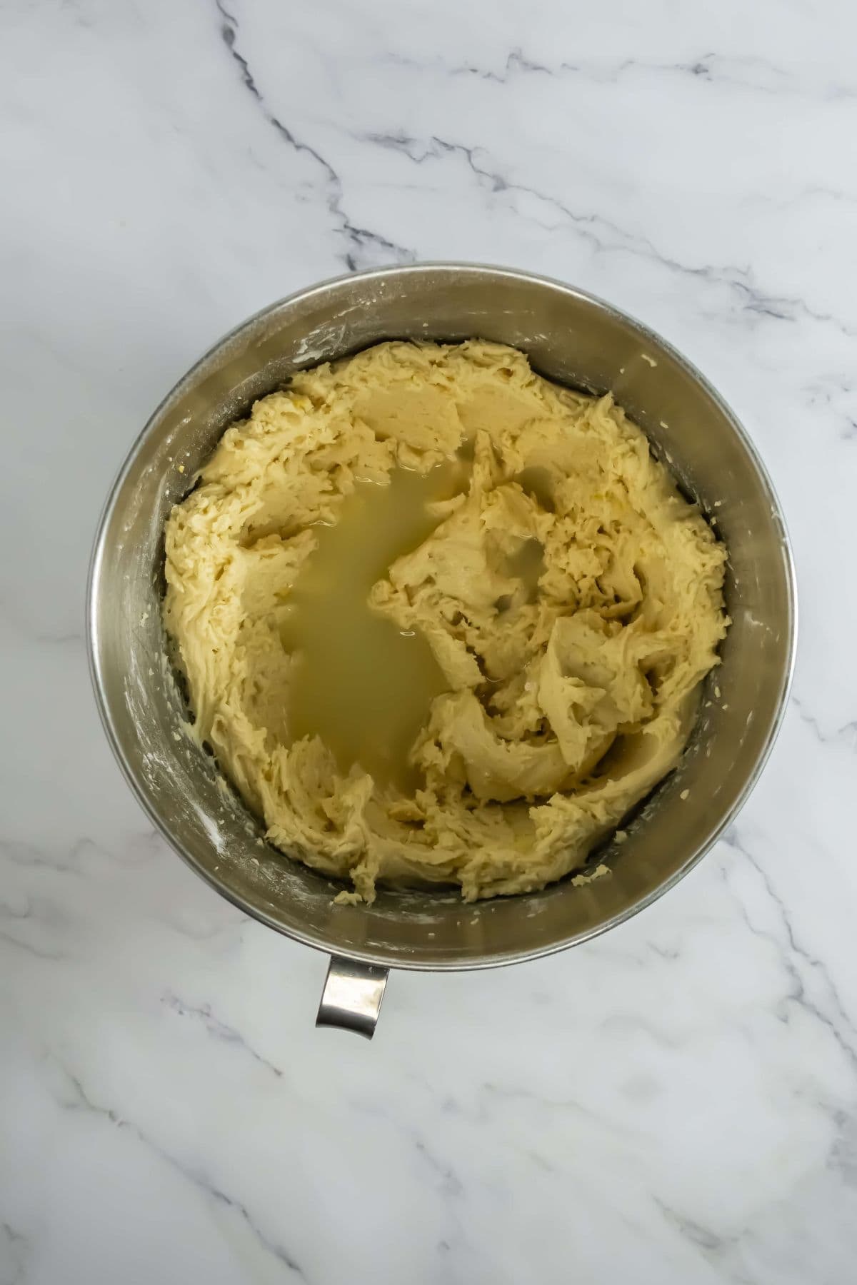 Thick cupcake batter being prepared in a mixing bowl.