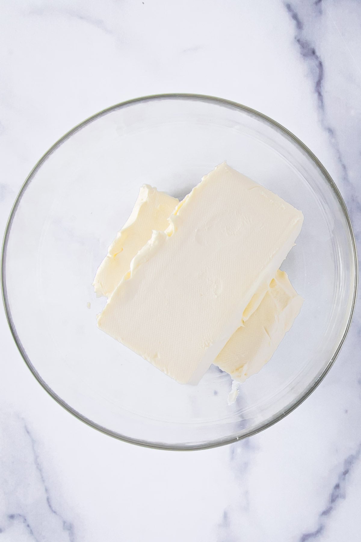 two blocks of cream cheese in a bowl