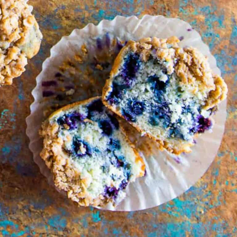 Buttermilk blueberry biscuit cut in half to show the blueberry inside and fluff moist muffin