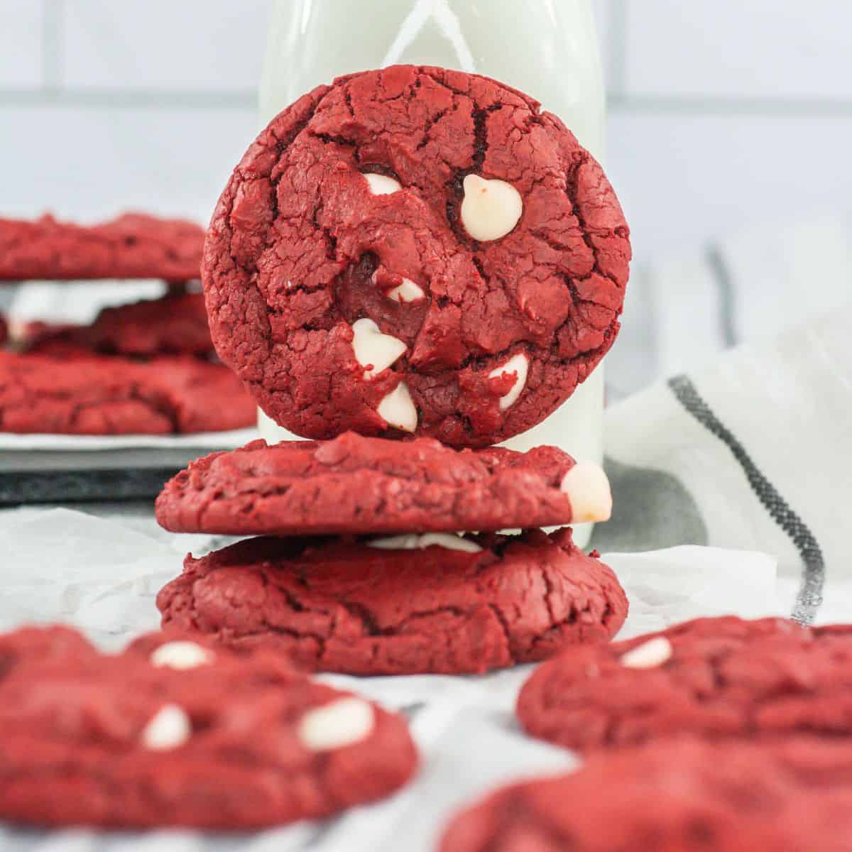A close-up of cake mix cookies leaning against a bottle of milk