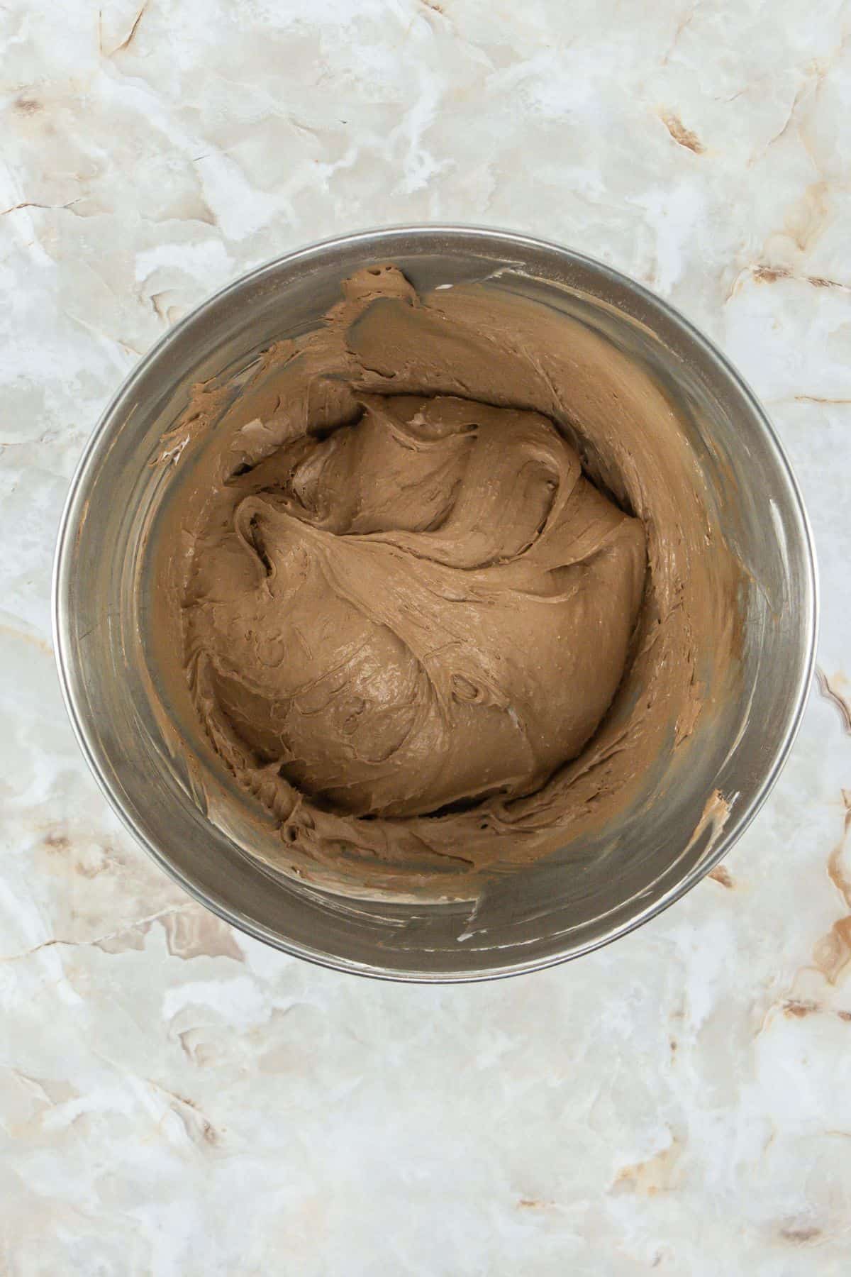 mixing bowl containing the fully mixed cool whip and cake mix cookie dough. 