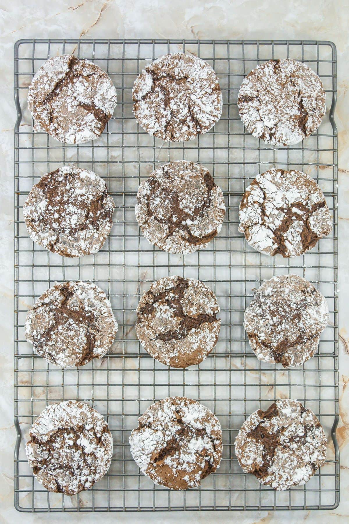 Baked cake mix cool whip cookies resting on a cooling rack.