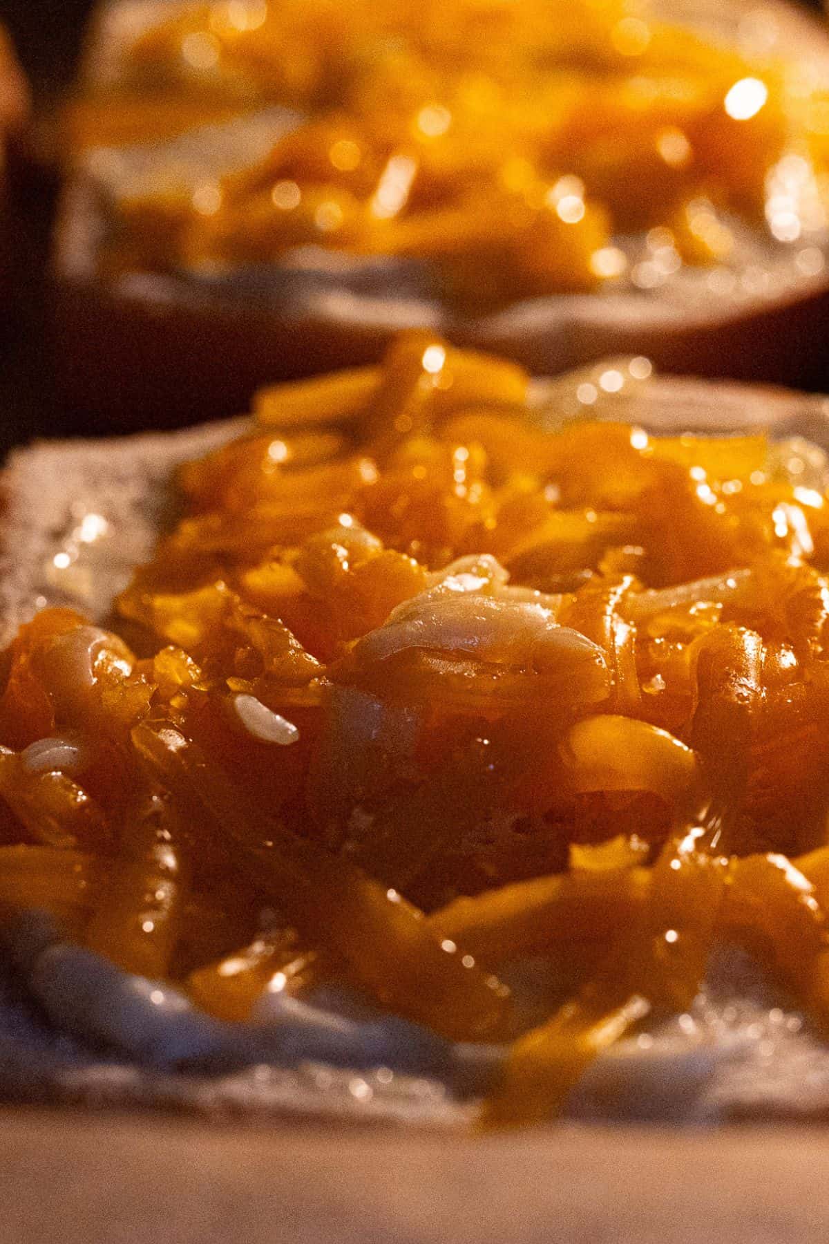 Cheese melting and bubbling on bread while baking.