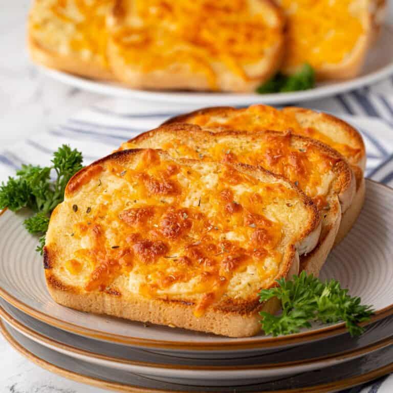 A close-up of the stacked cheese toast, highlighting the crispy, golden cheese topping.