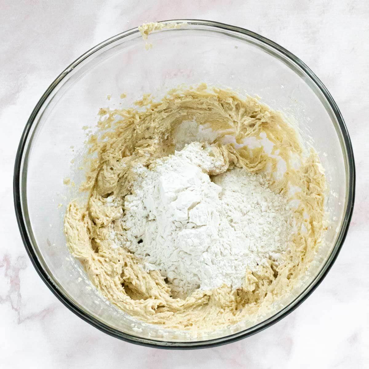 The cookie dough is being mixed with dry ingredients.