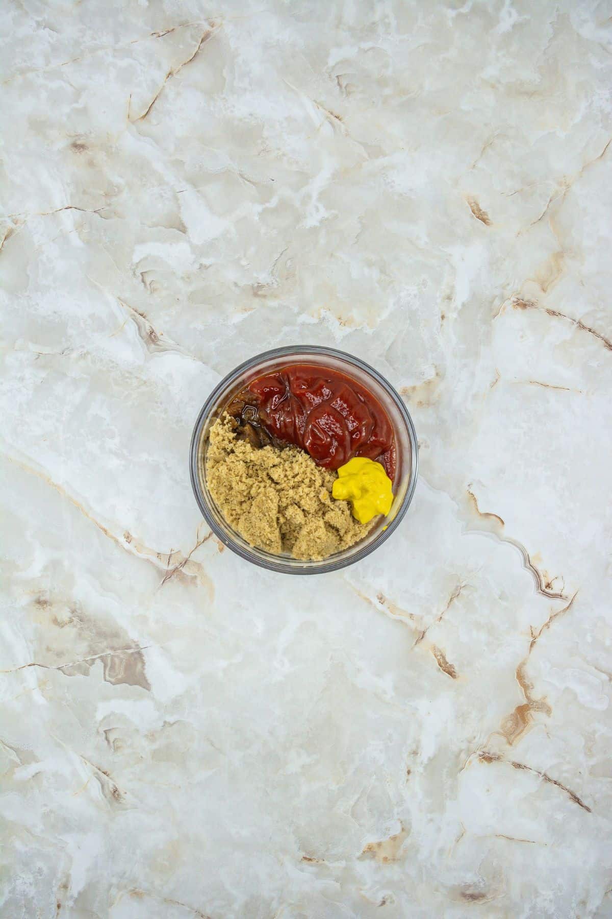a small bowl of ketchup, brown sugar, mustard, and Worcestershire sauce