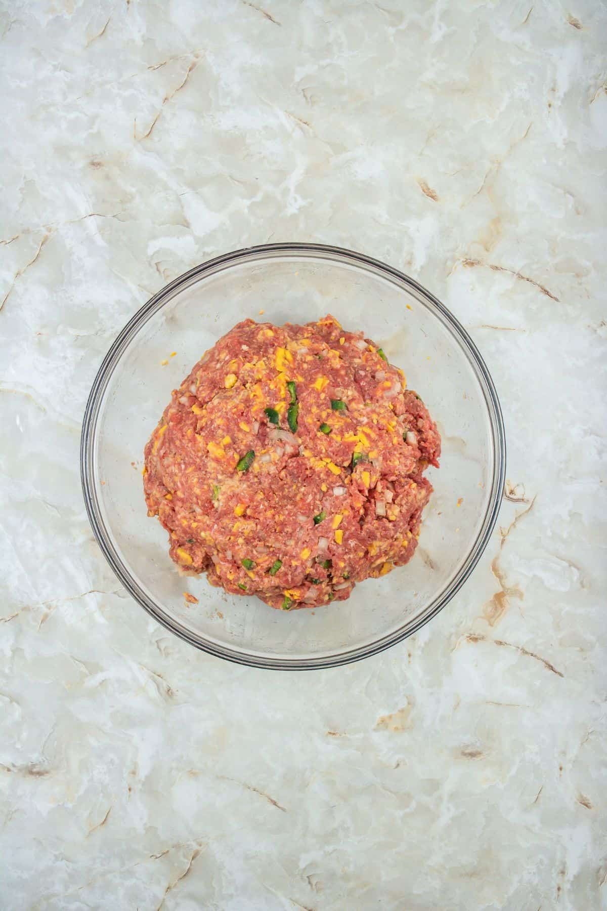 mixture of ground beef, onion, green pepper, eggs, cheese, milk, crushed Ritz crackers, salt, and pepper in a large bowl