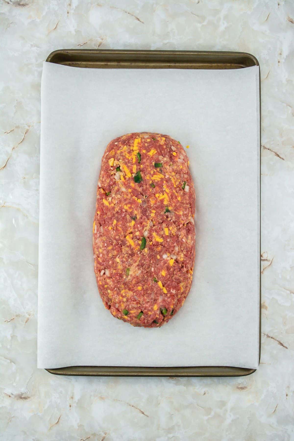 ingredients shaped into a rectangular loaf placed on a parchment-lined baking sheet