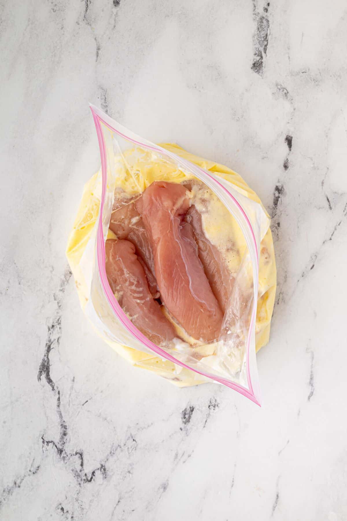 Chicken tenders coated in the wet mixture.