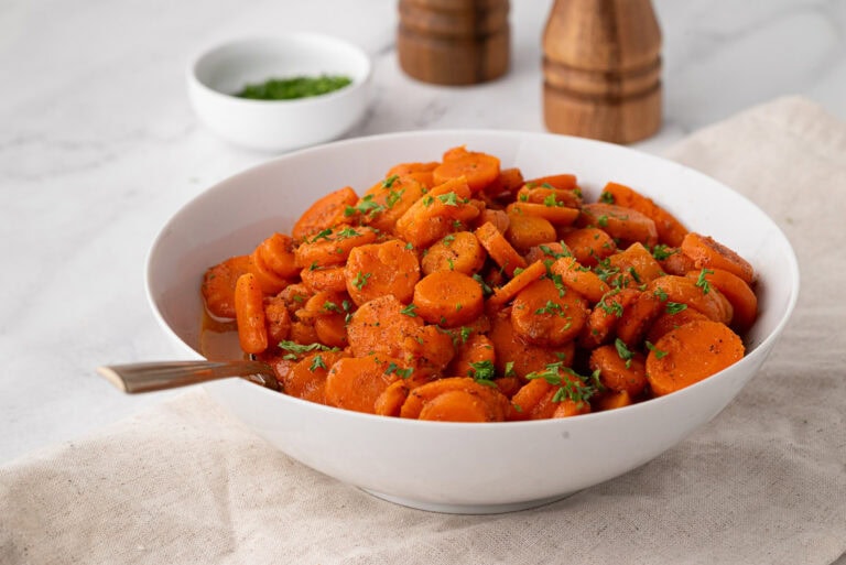 Bowl of canned carrots after cooking with seasoning.
