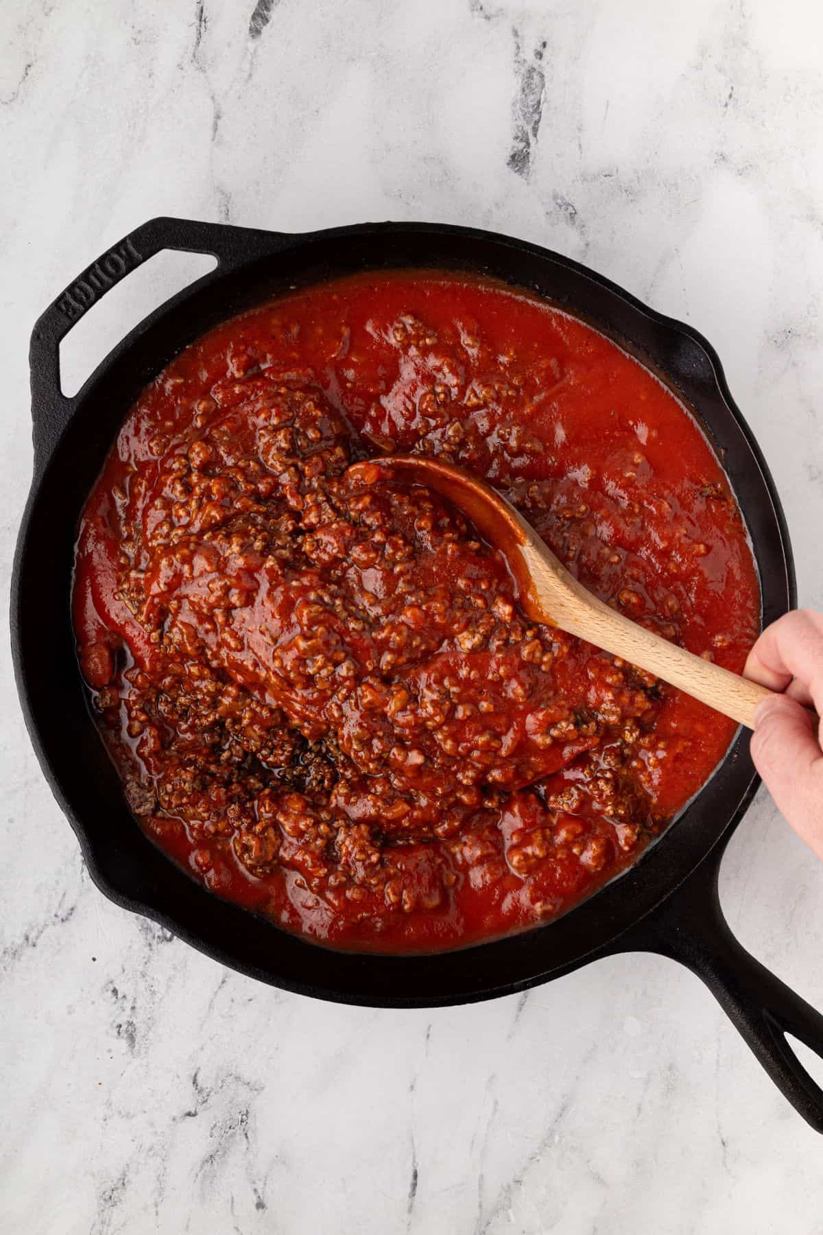Tomato sauce, tomato paste, and Worcestershire sauce are ready to be mixed in.