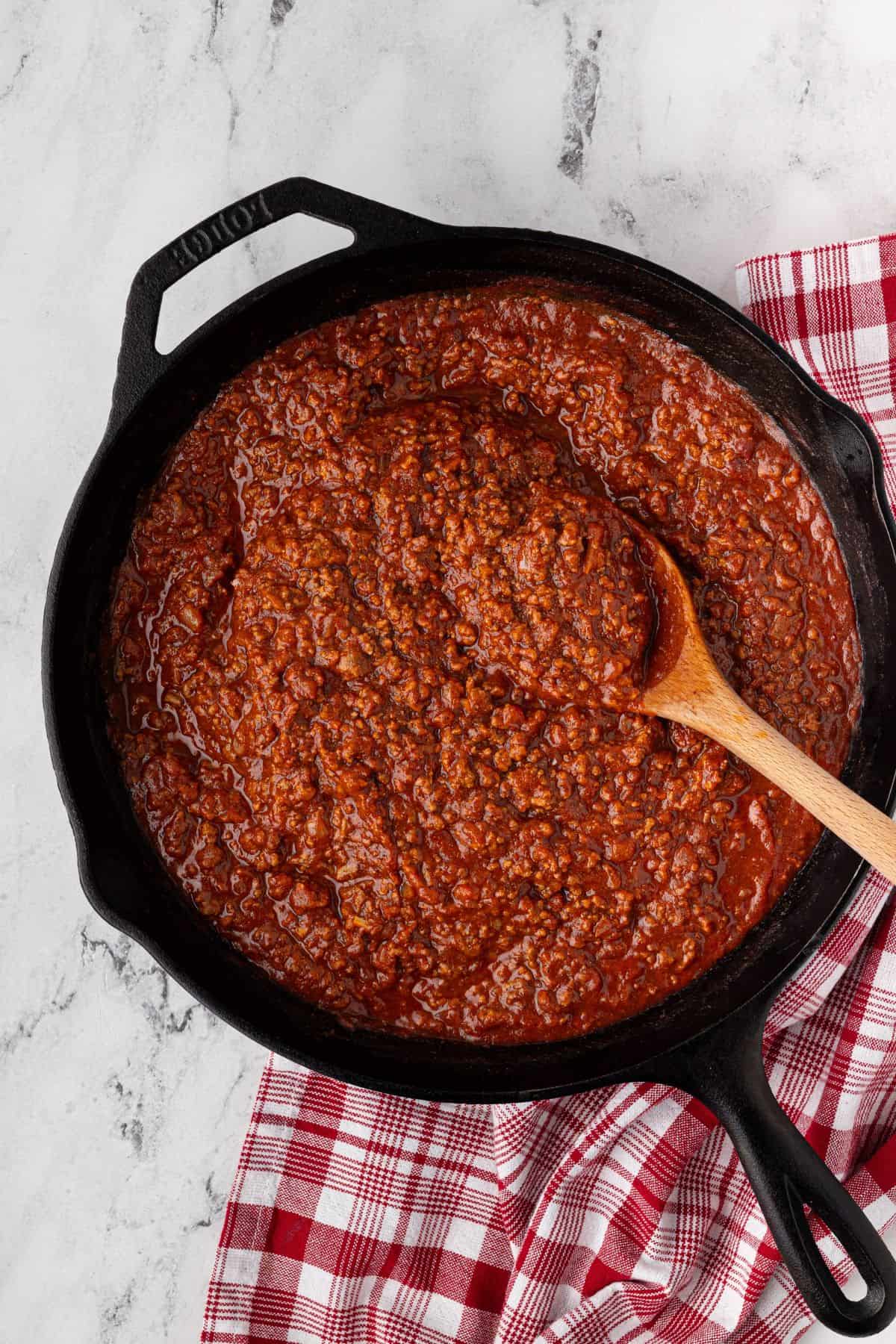 The sauce is stirred into the beef, creating a thick, rich mixture.