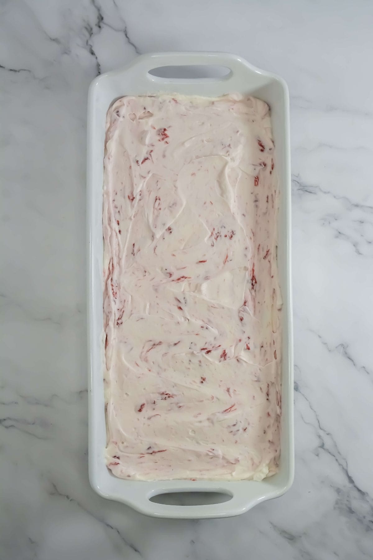 The mixture smoothed out in a rectangular dish, ready to be frozen.