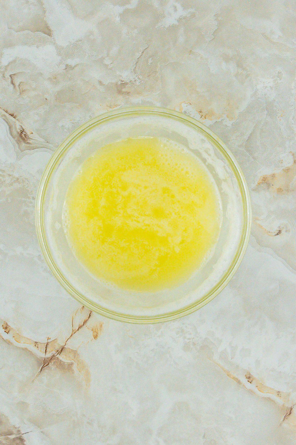A bowl filled with melted butter.