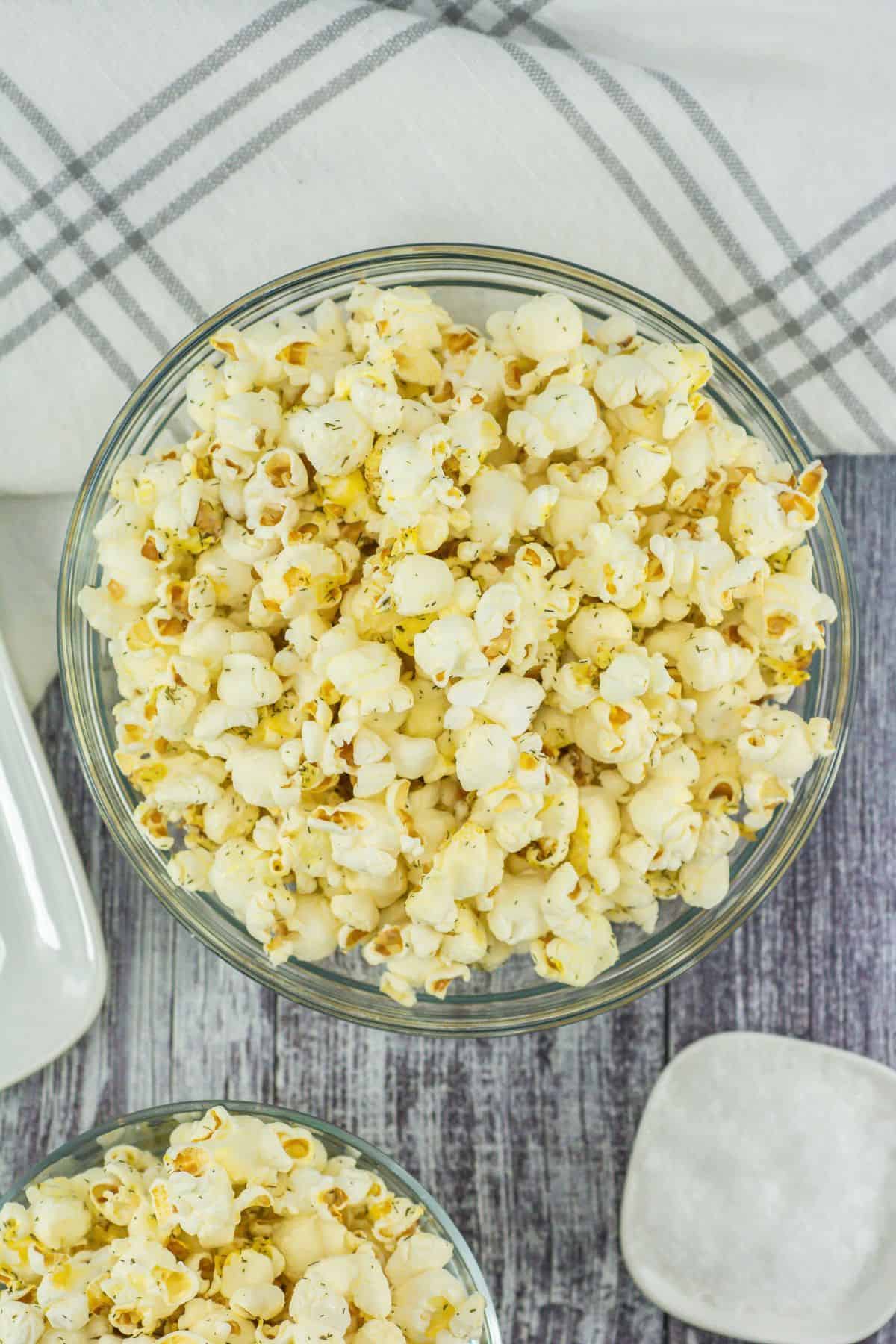 A bowl filled with fully seasoned and mixed popcorn.