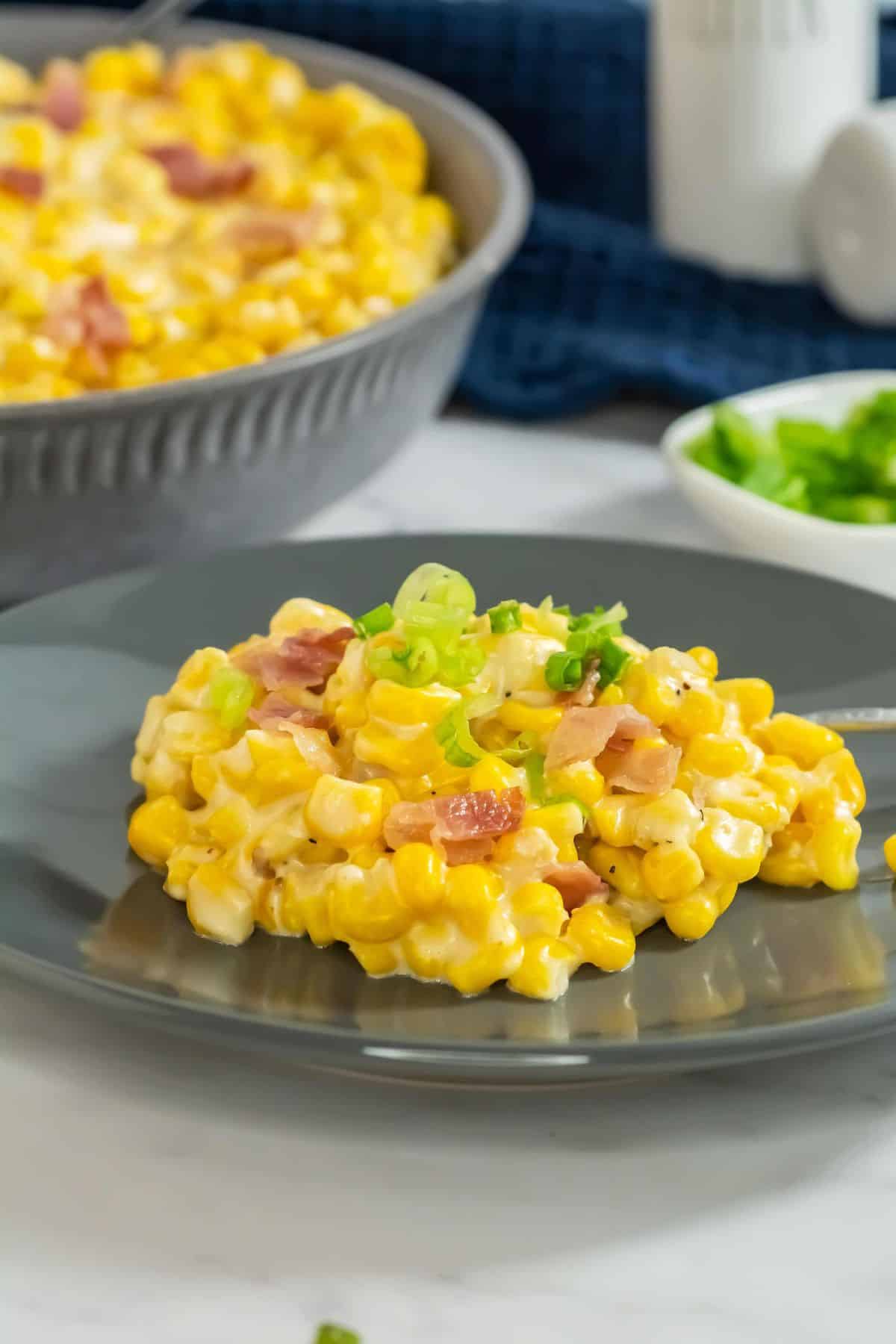 A creamy, cheesy corn mixture finished in the slow cooker, topped with crispy bacon pieces.
