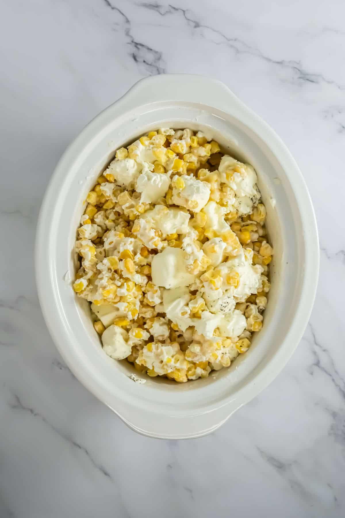 Cream cheese begins to melt and blend into the corn.