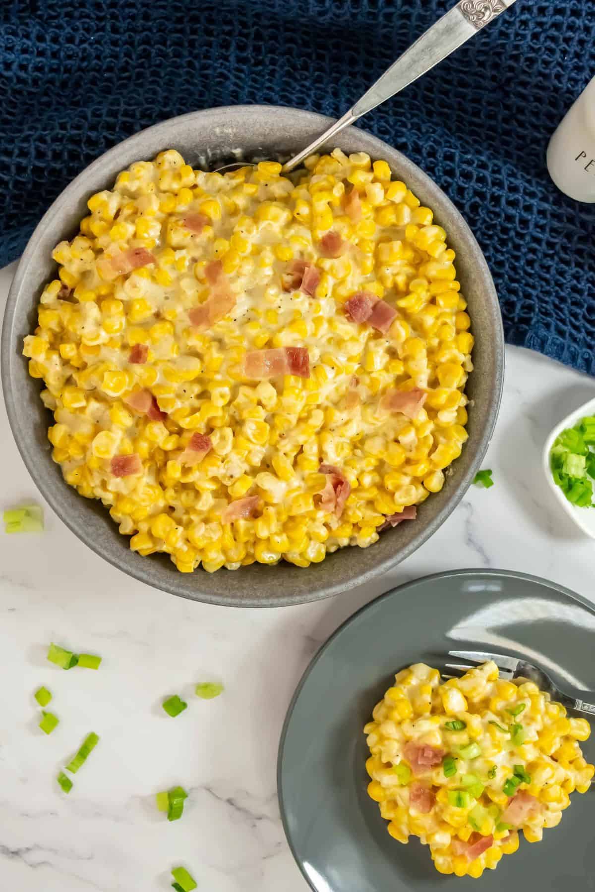 A close-up shot of the corn with garnishes served on a plate.