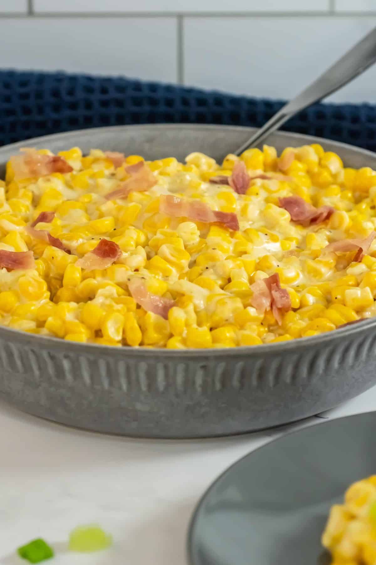 A detailed look at the creamy texture, vibrant corn, and bacon toppings served in a bowl.