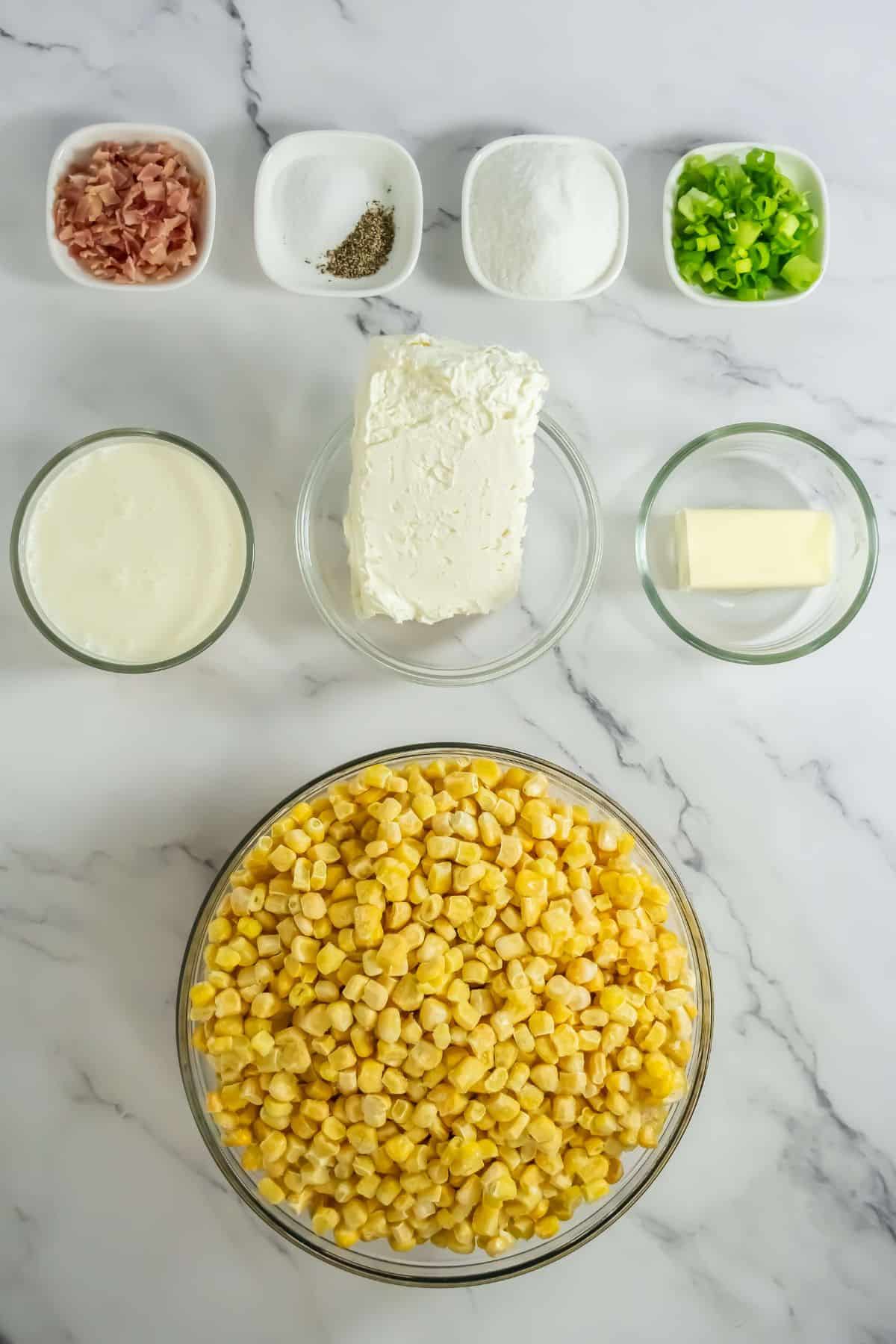 A clean layout of all ingredients—corn, cream cheese, butter, seasonings, bacon, and green onions—measured and ready to cook.