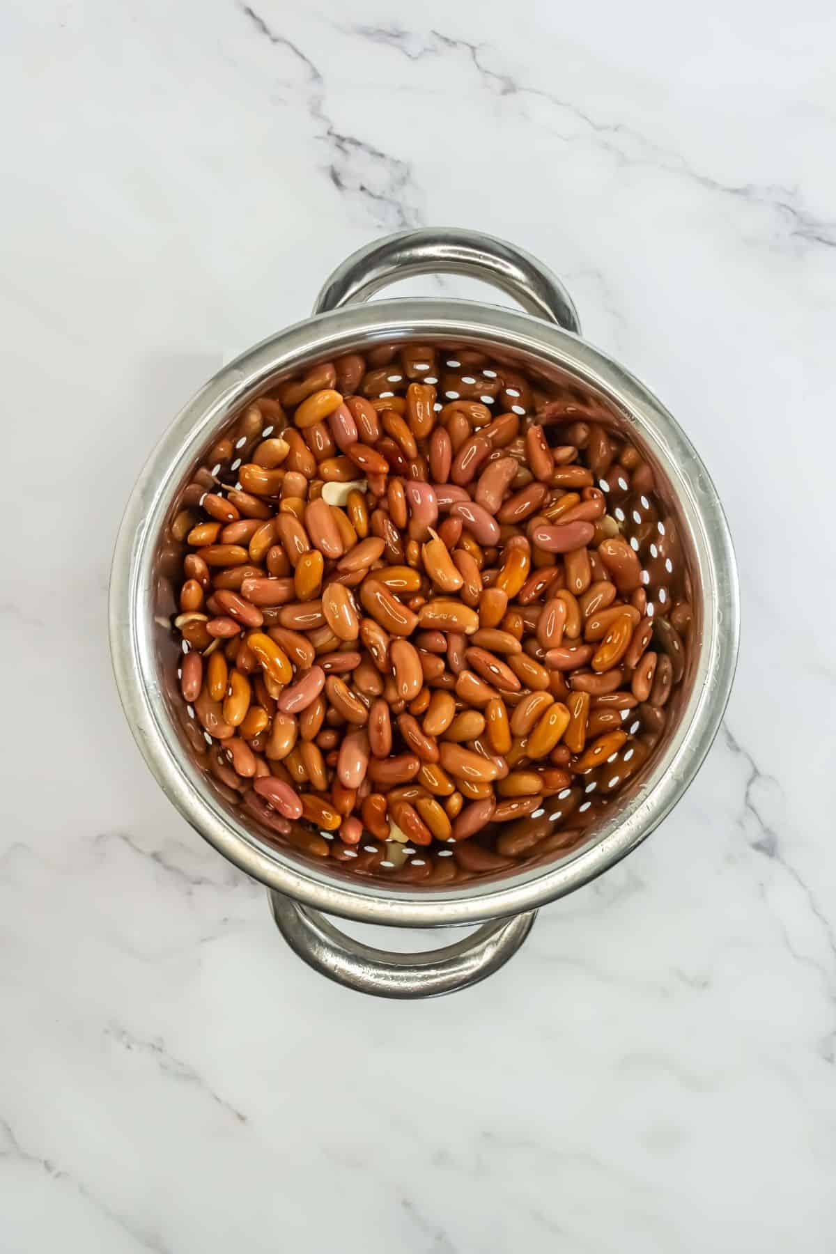 A colander filled with freshly rinsed red beans.