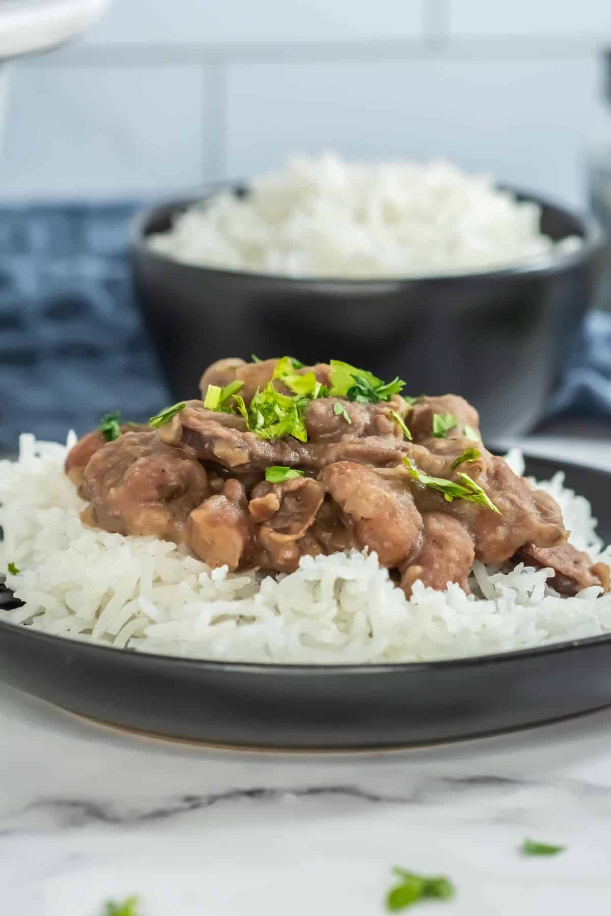 Side view of red beans and rice plated, showcasing the fluffy white rice and rich beans