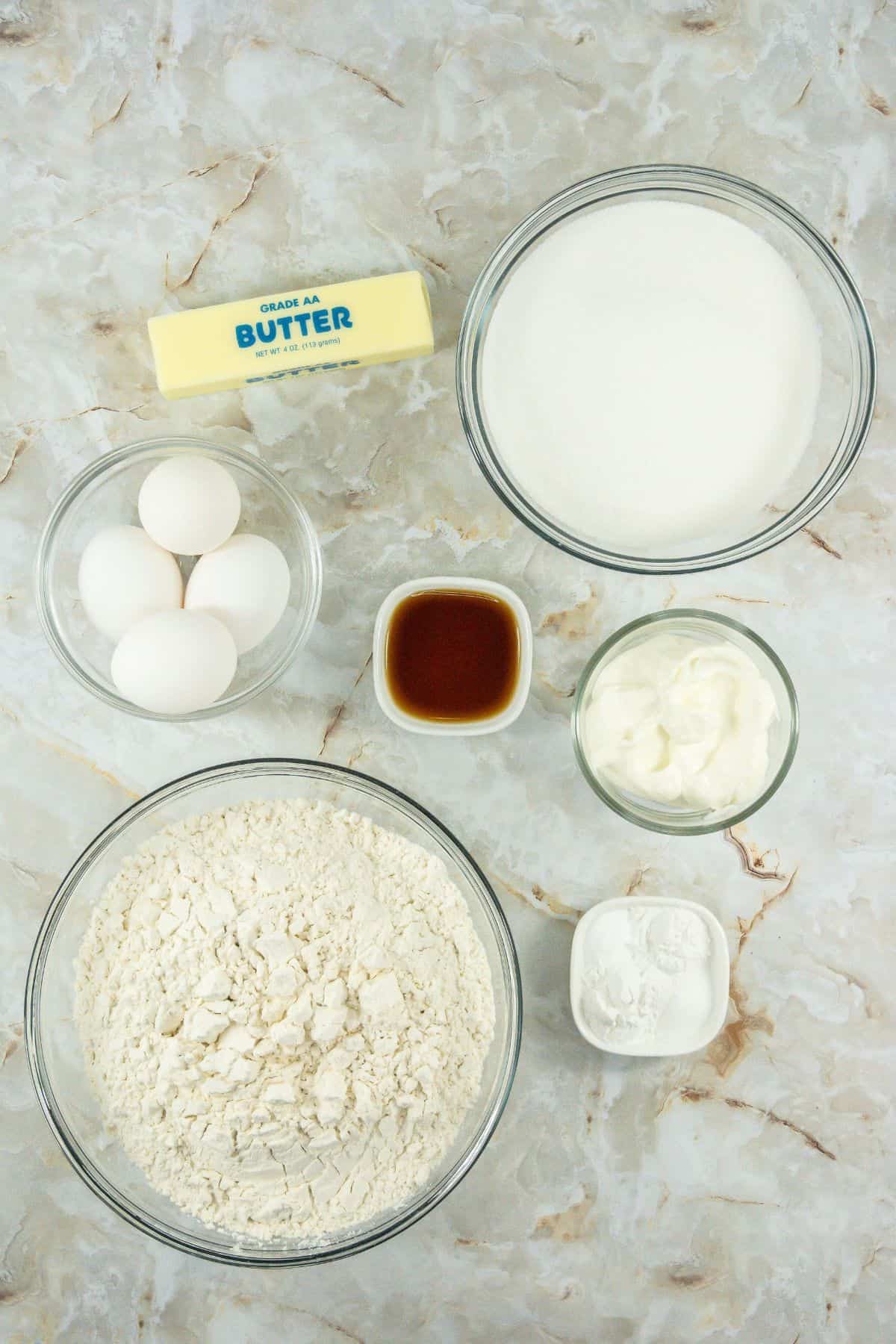 Sour Cream Cookies ingredients unsalted butter, sugar, eggs, vanilla, sour cream, baking soda, baking powder, salt, flour, milk, powdered sugar