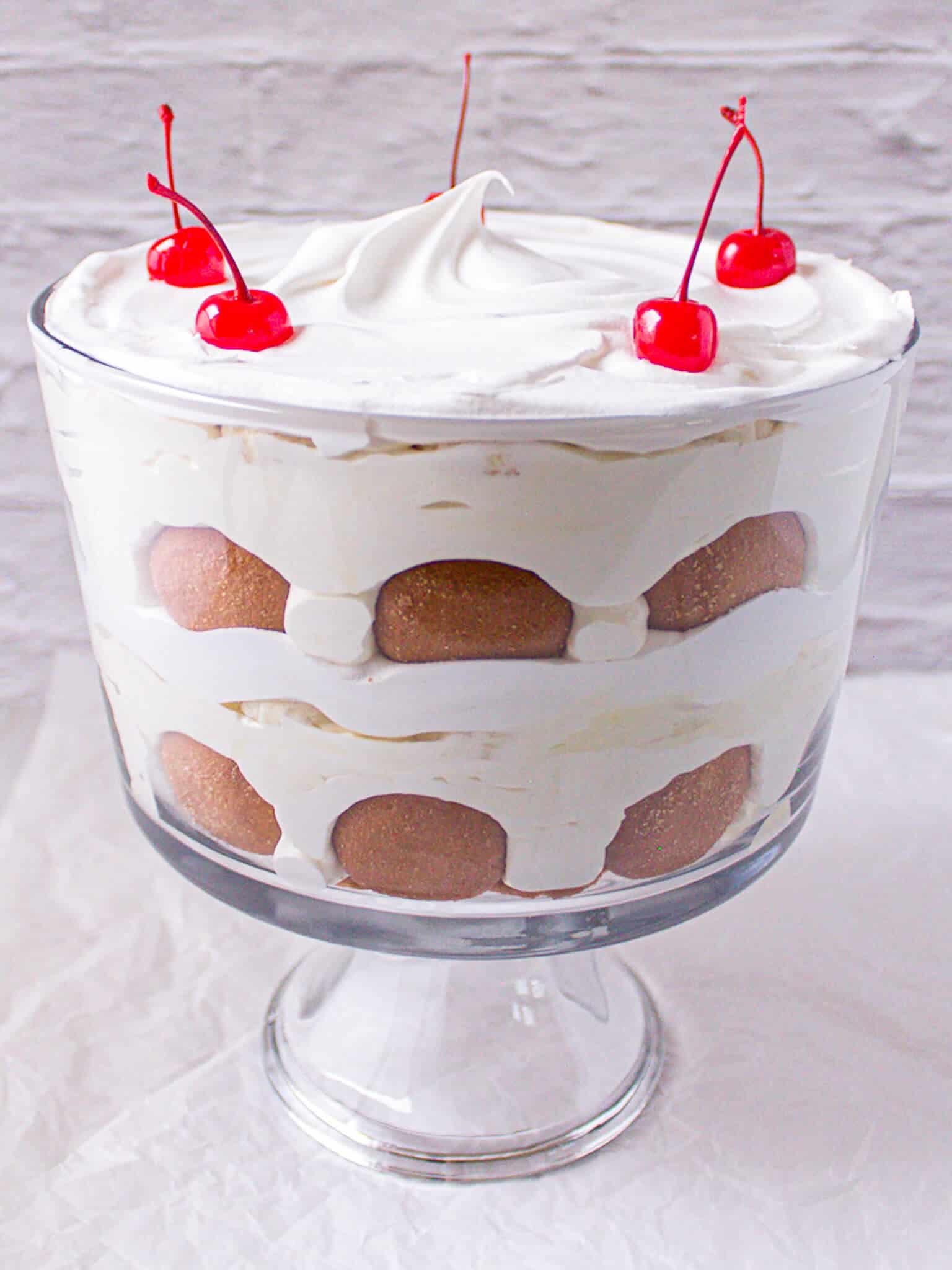 Layered banana pudding with cookies and whipped topping.