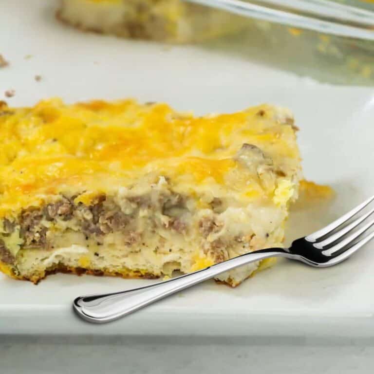 slice of biscuits and gravy casserole on a plate with a fork