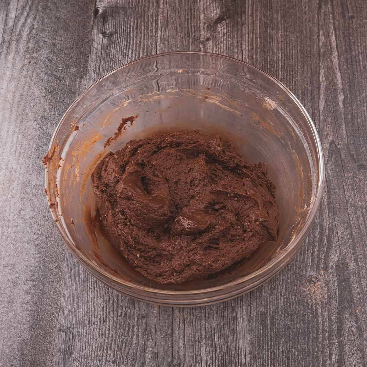 Thick, chocolatey cookie dough fully mixed.