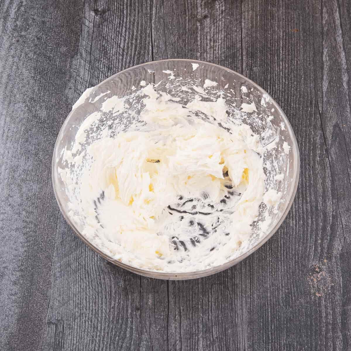 Softened cream cheese beaten until smooth in a glass bowl.
