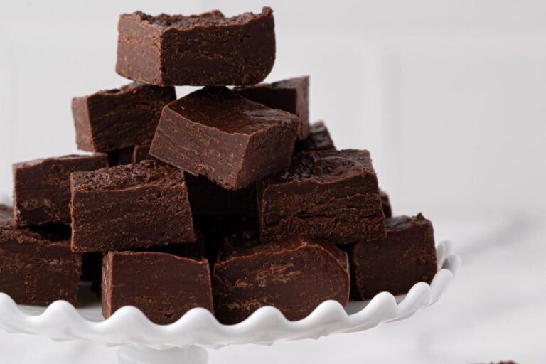 chocolate fudge stacked on a serving platter made with sweetened condensed milk, chocolate and butter.