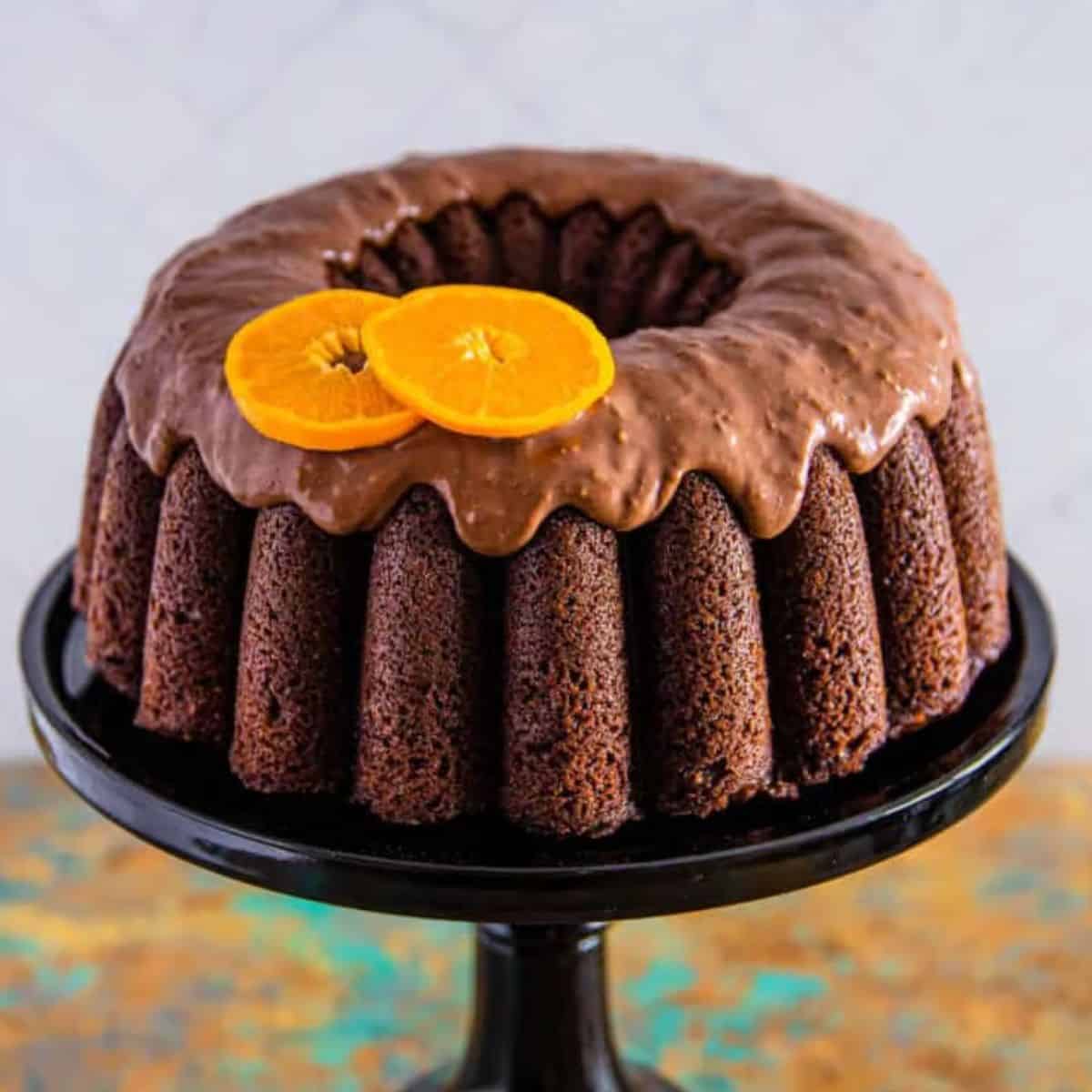 chocolate orange cake with a orange and chocolate ganache on a cake stand