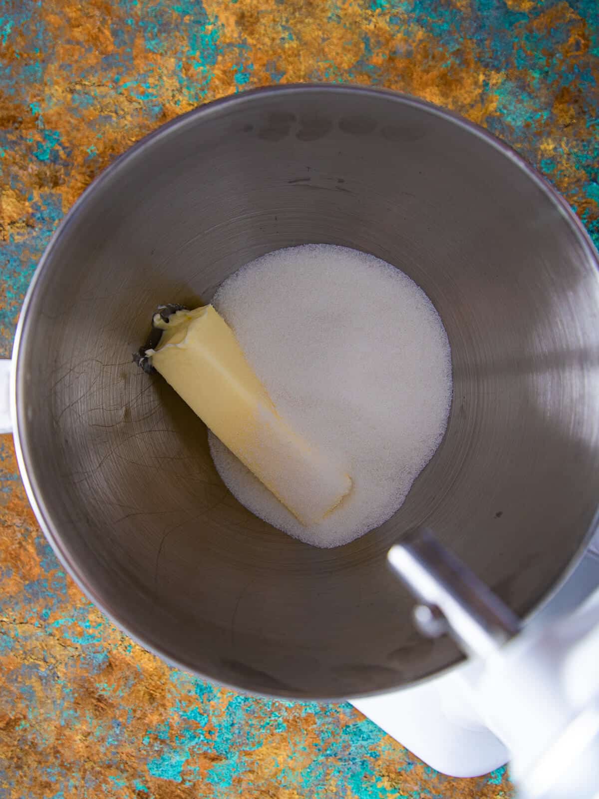 A stand mixer with butter and sugar about to be creamed.
