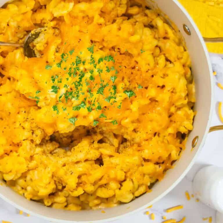 large pot of hidden veggie mac and cheese topped with extra cheese and parsley