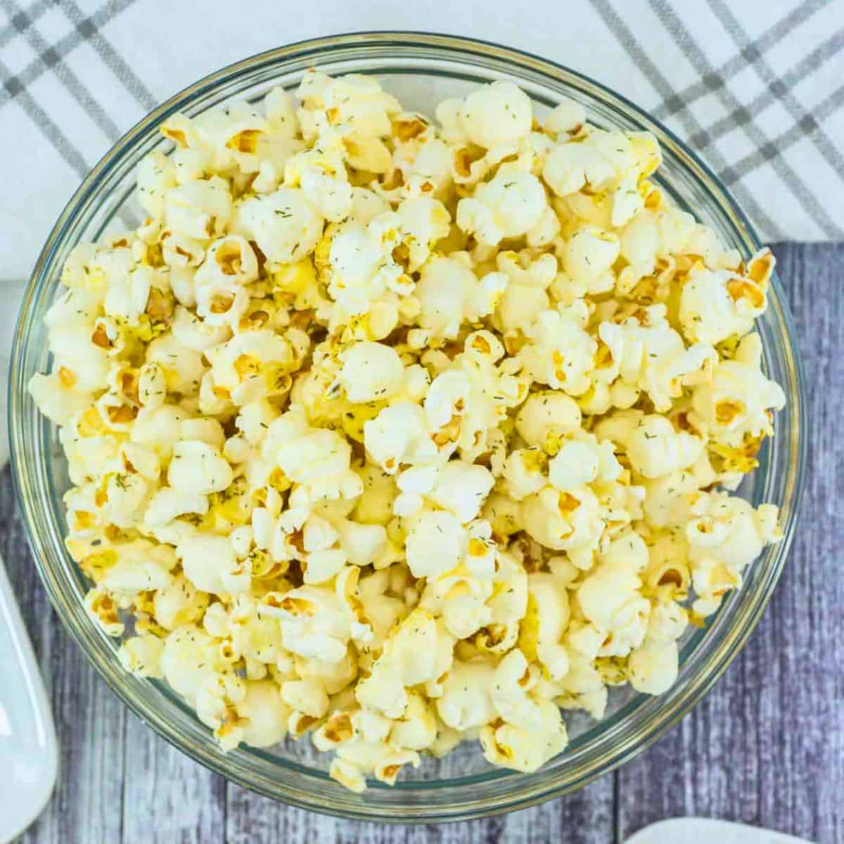 salt and vinegar seasoned popcorn in a clear glass bowl