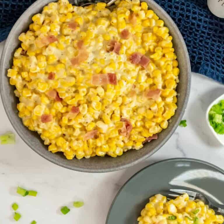 a serving bowl with slow cooker creamed corn filled to the brim